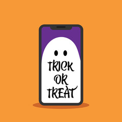 Trick or treat letters on a smartphone with an orange background. Halloween concept.