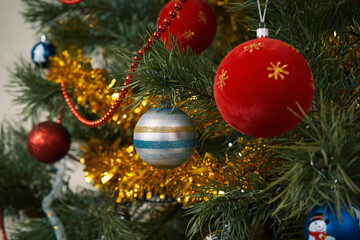 Close-up shot of New Year's toy balls on the branches of a Christmas tree