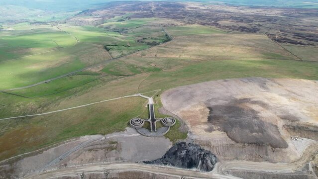 Aerial high drone shot of Coldstones Cut landmark next to Hanson Aggregates Quarry in Harrogate, North Yorkshire, UK