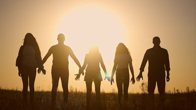 teamwork. team community a holding hands together silhouette at unity sunset. group of people hands. teamwork of workers. team in the company running lifestyle partnership business community hand