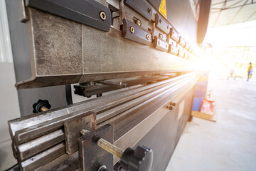 Large steel folding machines in industrial plants.