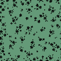 seamless vintage pattern. small black flowers and leaves. green background. vector texture. fashionable print for textiles and wallpaper.