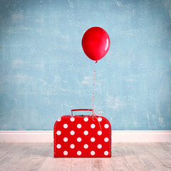 Koffer mit roten Ballon