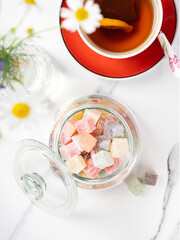 Turkish Delight. view of the tol with a cup of tea and Turkish delight sweets on a plate. A traditional oriental treat is sweetness.