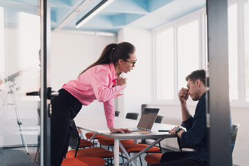 Emotional couple of young colleagues arguing in modern office. African-american business woman shouting at her sad man assistant, copy space, side view
