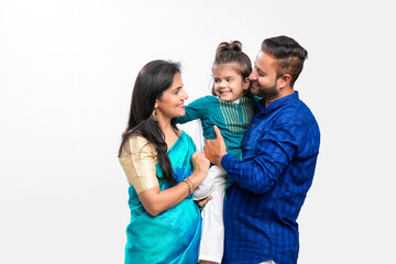 Happy indian couple with her daughter standing on white background.