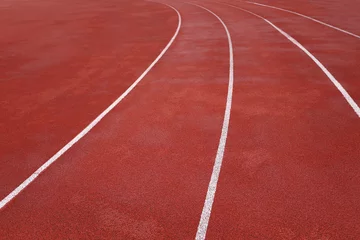 Gordijnen Red treadmill on sport field. Running track on the stadium with rubber coating © Michael