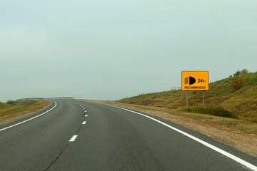 Road sign, Attention, it is recommended to drive on the highway with the headlights on