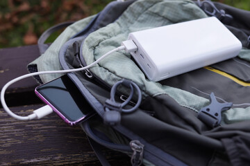 Smartphone with power bank on the travel backpack