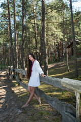 Long-haired Ukrainian girl in an embroidered national shirt in the forest