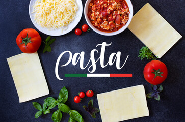 Ingredients for cooking lasagna. Recipe for homemade Italian lasagna with tomato sauce and meat black background with the word pasta. Tomatoes, basil, meat sauce, mozzarella cheese, lasagna pasta