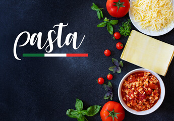 Ingredients for cooking lasagna. Recipe for homemade Italian lasagna with tomato sauce and meat black background with the word pasta. Tomatoes, basil, meat sauce, mozzarella cheese, lasagna pasta
