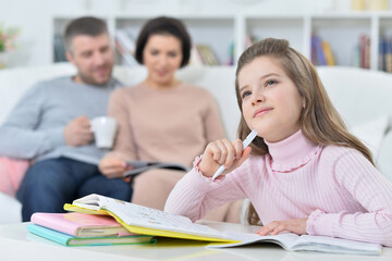 Beautiful little girl doing homework at home