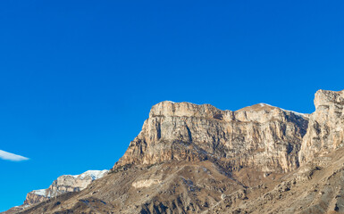 a mountain peak on a blue sky background