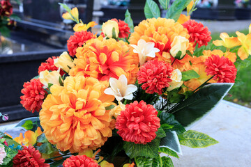 Beautiful bouquet with artificial orange roses and chrysanthemums. © agneskantaruk