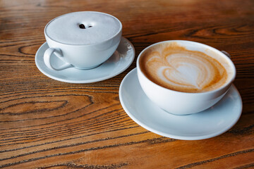 Two cafe latte on wood