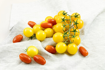 yellow and red cherry tomatoes on a light background
