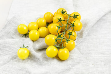 yellow tomatoes on a branch