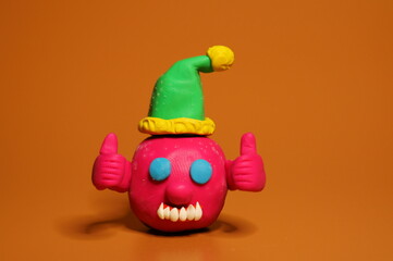 A figure of a joyful virus in a festive hat. Decorations for the new year.