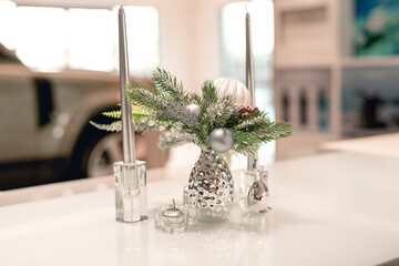 Christmas decoration of a car dealership. New Year's car sale. Silver Christmas decorations and tinsel. Festive mood in the business center. Toy rabbit. Symbol of the year 2023