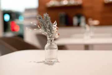 Naklejka na ściany i meble Christmas decoration in a cafe. New Year's composition in the restaurant. Silver Christmas toys and tinsel. Festive mood in the workplace. No people
