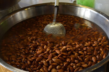Arab market in Israel. Wet almonds. Large bowl with almonds, Arabic sweets.