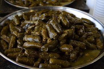 Arabic dolma, Israeli cuisine - aley gefen. Delicious dolma stuffed grape leaves rice. Lebanese dolma sarma on plate. Lebanon turkish greek middle eastern cuisine. Yaprak sarma