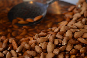 Arab market in Israel. Wet almonds. Large bowl with almonds, Arabic sweets.
