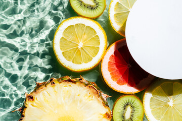 White circle copy space with lemon, kiwi, orange, pineapple, grapefruit, lemon, pomelo water splash transparent surface