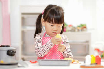 young  girl pretend play food preparing at home