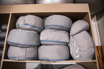 meditation pillows on a shelf in the closet. equipment for yoga classes.