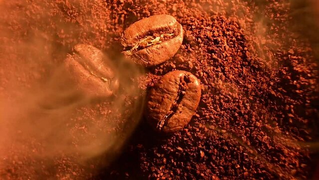 Video with roasted coffee beans close-up and light smoke, coffee illumination with warm light.
