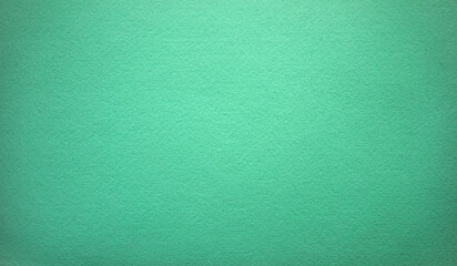 Photo of the texture of green felt fabric.Bright green background for text.Industrial sheet felt for production.