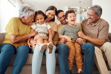 Happy, big family and quality time bonding of children, parents and grandparents together on a sofa. Laughing kids having fun with mom, dad and grandparent on a home living room couch with happiness