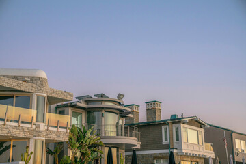 Fototapeta na wymiar La Jolla, California- Row of beach houses with sunset glow on reflective glass panes