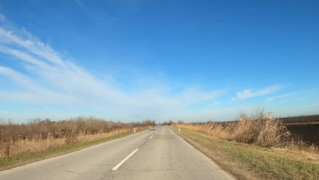 Driving plate, drive along the empty road through countryside landscape, car dashcam pov