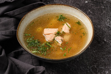 fish soup with salmon on a dark background