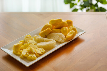 pineapple pomelo and jackfruit on a white plate