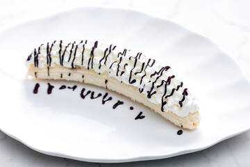 banana with whipped cream and chocolate topping