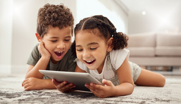 Tablet, children and family with a brother and sister watching movies on a living room floor together. Internet, kids and technology with a girl and boy streaming online subscription service at home