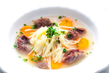 beef broth with noodles and carrot