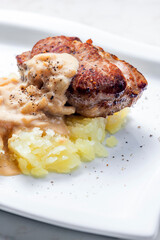 grilled meat with mashed potatoes with onion sauce