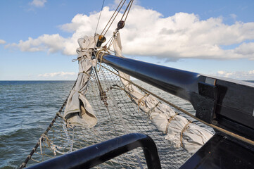 Mast and rigging of an old sailing ship in Netherlands with horizon at background