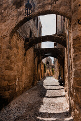 Fototapeta premium Narrow cobbled historical streets in Old Town of Rhodes, Dodecanese, Greece. High quality photo