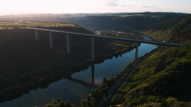 Romantic aerial drone flyover the Moseltalbr&uuml;cke and highway A61 over moselle valley, bridge connecting the Eifel mountains - Moselle Viaduct, Winningen, Germany establishing shot 2022