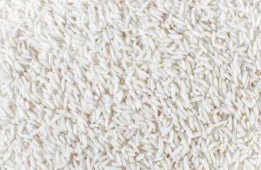 Lots of white rice grains. A pile of white rice grains. Use as a background or wallpaper.