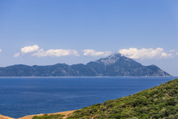 Fototapeta na wymiar Slhouette of Mount Athos and the peninsula of the same name protruded into the Aegean Sea. Chalkidiki, Greece.