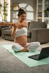 Fototapeta na wymiar Beautiful pregnant woman practising yoga at home..