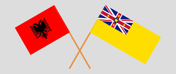 Crossed flags of Albania and Niue. Official colors. Correct proportion