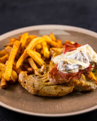 typical czech cuisine chicken slice baked with ham and camembert with french fries